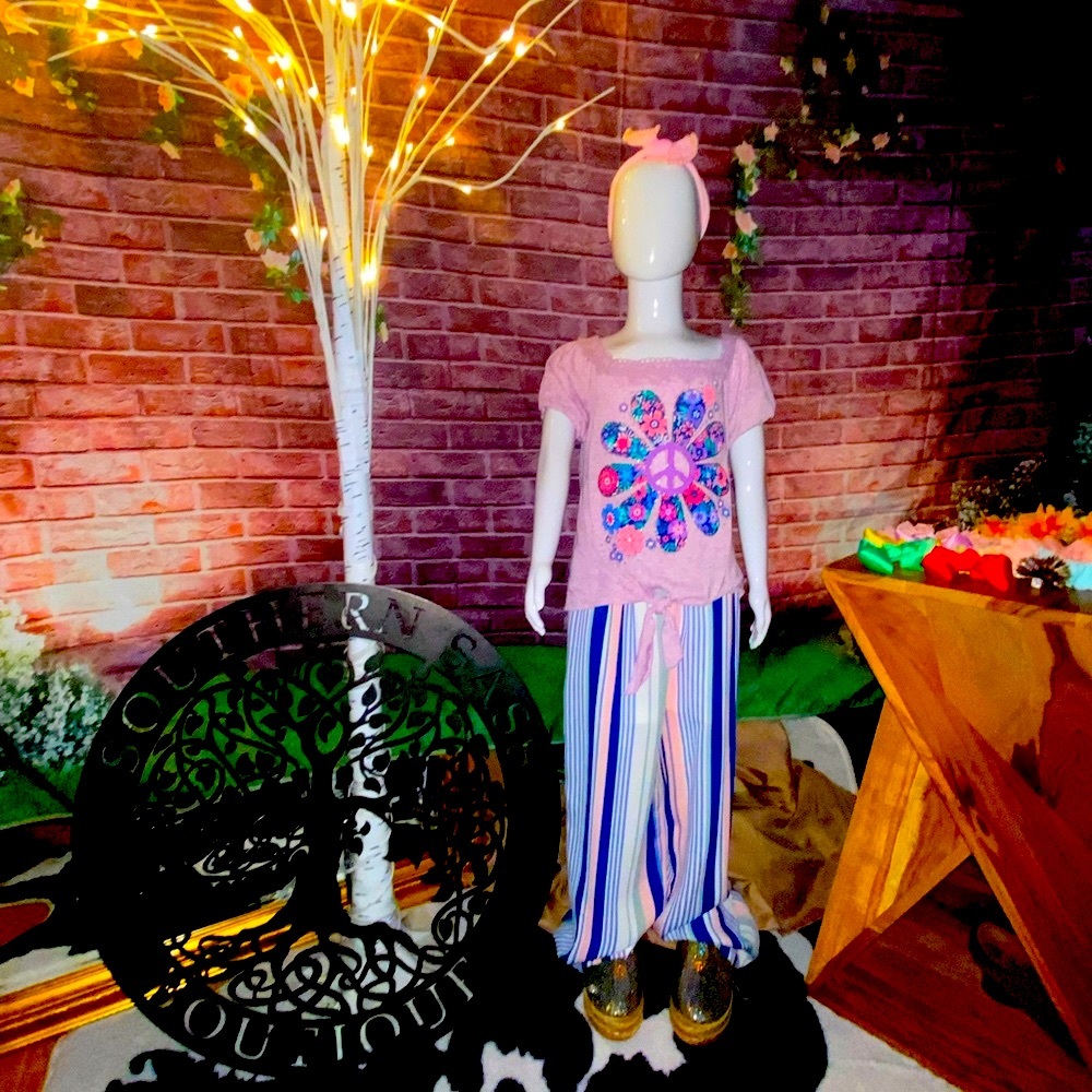 Striped elastic waist wide-leg pants with a lilac peace daisy tie front shirt.
